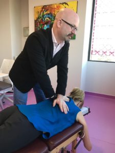 Dr. Lou performing chiropractic services in portland, maine